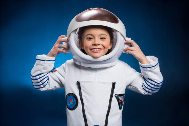 Little girl in space suit Little girl in space suit wearing helmet  and smiling at camera space and astronomy stock pictures, royalty-free photos & images
