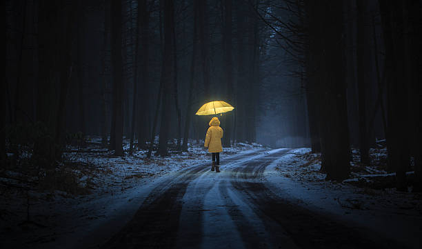 Little girl in the dark forest Little girl in the yellow coat with umbrella in the dark forest at night. Homage to Little Red Riding Hood ugly girl stock pictures, royalty-free photos & images