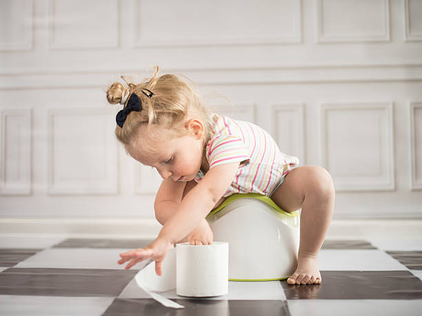 Little girl on potty stock photo