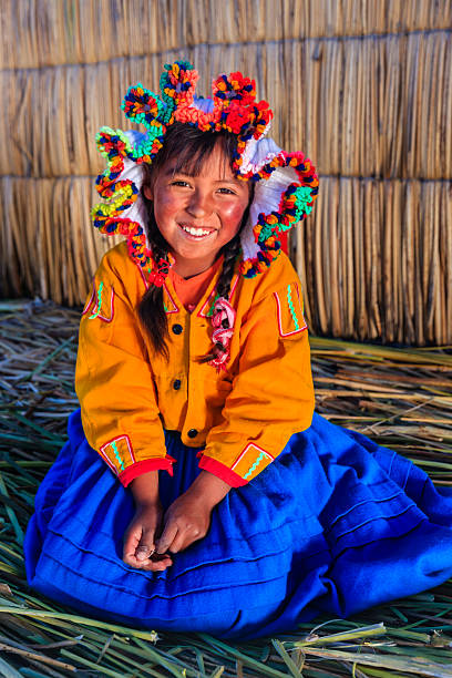 Little girl on Uros floating island, Lake Tititcaca, Peru Uros are a pre-Incan people that live on forty-two self-fashioned floating island in Lake Titicaca Puno, Peru and Bolivia. They form three main groups: Uru-Chipayas, Uru-Muratos  and the Uru-Iruitos. The latter are still located on the Bolivian side of Lake Titicaca and Desaguadero River. The Uros use bundles of dried totora reeds to make reed boats (balsas mats), and to make the islands themselves. The Uros islands at 3810 meters above sea level are just five kilometers west from Puno port.http://bem.2be.pl/IS/peru_380.jpg peru girl stock pictures, royalty-free photos & images