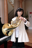 Little Girl Playing French Horn