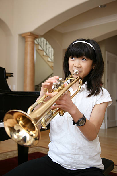 Little Girl Playing Trumpet stock photo