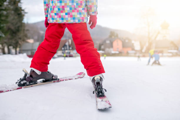 Little girl preparing to ski downhill stock photo