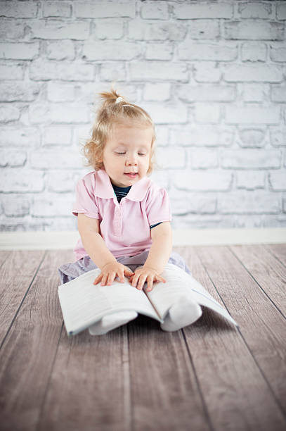 Little girl read magazine stock photo