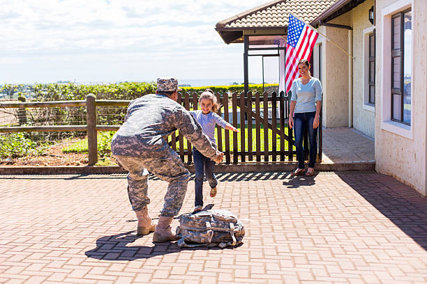 little girl running to her military father excited little girl running to her military father soldiers returning home stock pictures, royalty-free photos & images