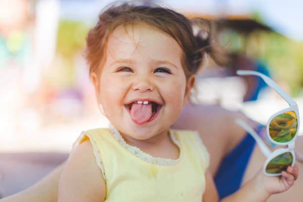 Little girl sticking her tongue out stock photo