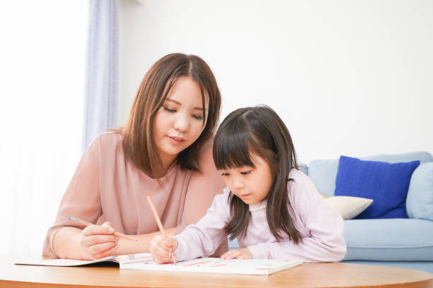 A little girl studying with her mother A little girl studying with her mother child korea little girls korean ethnicity stock pictures, royalty-free photos & images