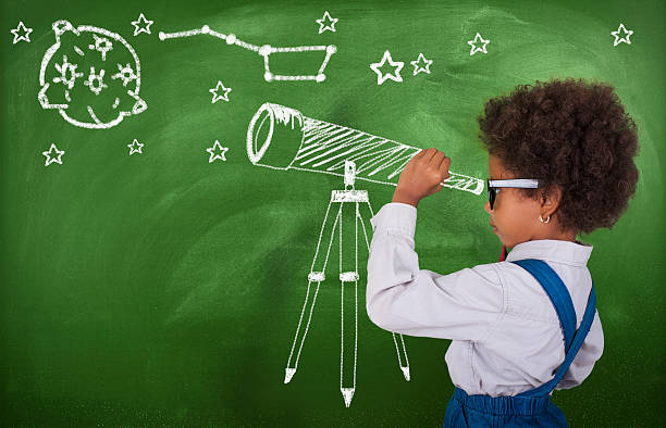 little girl using his imagination to look at stars - de ruimte en astronomie stockfoto's en -beelden