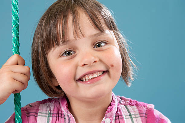 little girl with big smile stock photo