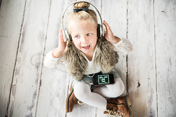 Little girl with headphones stock photo
