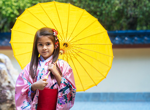 Little girl with kimono and umbrella