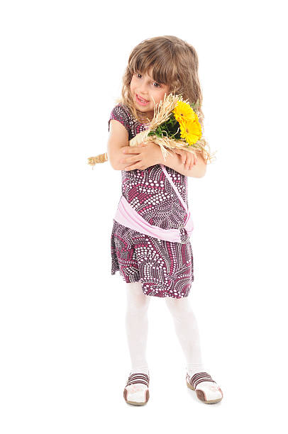 Little girl with the flowers stock photo