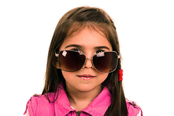Little girl with too big glasses stock photo