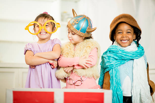 Little Girls in Costume Little girls dressed in theatrical costume laughing and smiling together. acting performance stock pictures, royalty-free photos & images