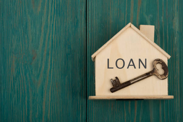 little house with text "LOAN" and key stock photo