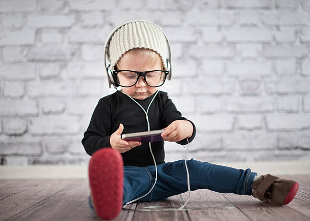 Little nerd with music player stock photo