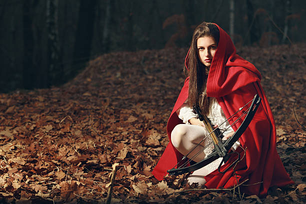 Little red riding hood  in the dark forest stock photo