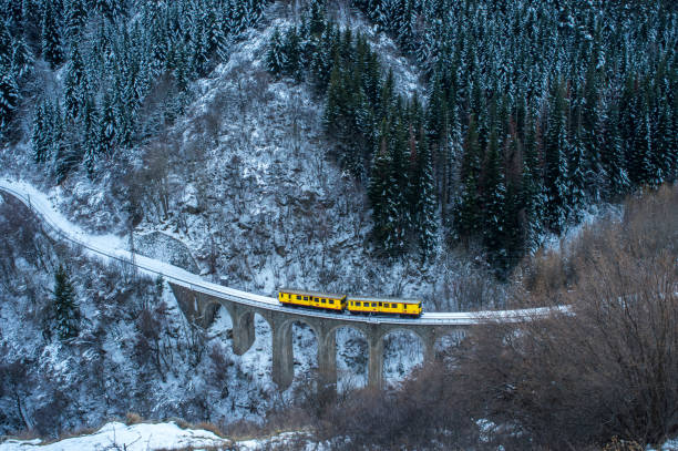 Little Yellow Train travelling in winter stock photo