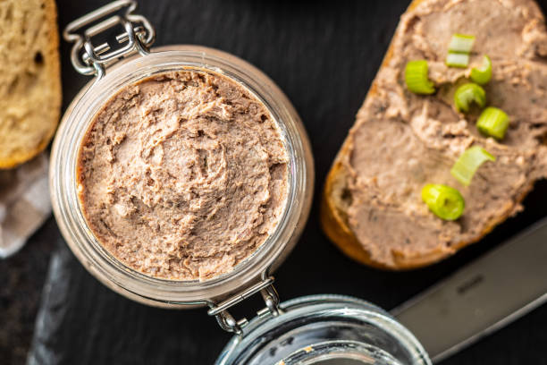 Liver pate in jar Liver pate in jar on black table. Top view. pate stock pictures, royalty-free photos & images