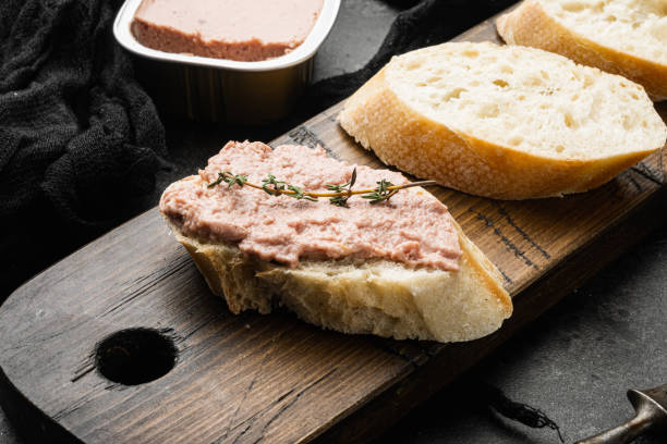 Liver pate on toast, on black dark stone table background Liver pate on toast set, on black dark stone table background liver pâté photos stock pictures, royalty-free photos & images