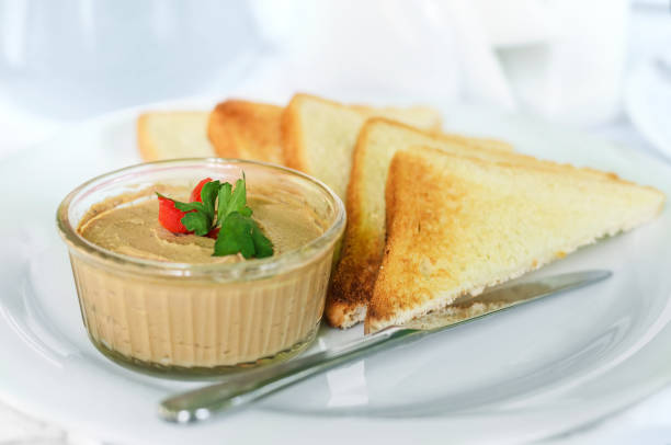 Liver pate with toast Homemade liver pate with crispy slices of bread. Close-up, selective focus liver pâté photos stock pictures, royalty-free photos & images
