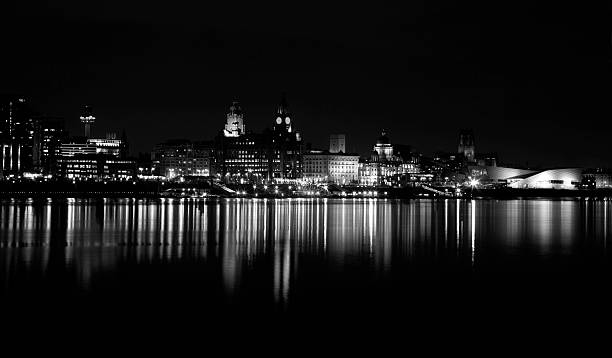 Liverpool Cityscape A time exposure monochrome version of Liverpools iconic World Heritage waterfront on a still flat calm evening on the River Mersey cunard building liverpool stock pictures, royalty-free photos & images