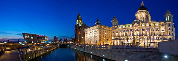 Liverpool Panoramic A twilight panoramic view of the Three Graces in Liverpool cunard building liverpool stock pictures, royalty-free photos & images