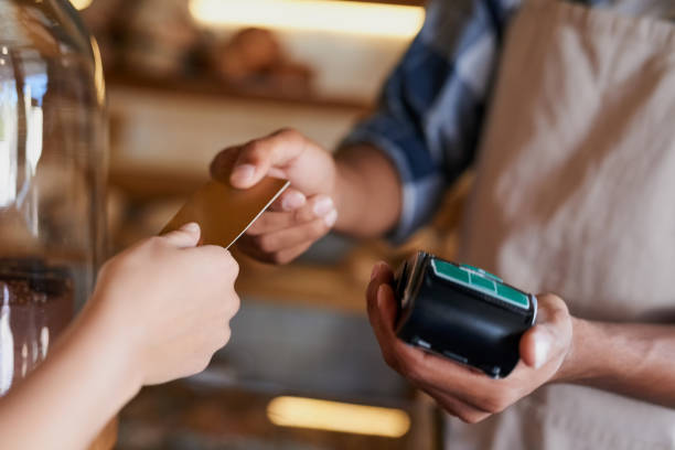 I'll checkout on credit Closeup shot of a customer making a credit card payment in a cafe online fraud in restaurants stock pictures, royalty-free photos & images