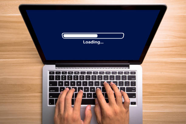 Loading Concept Laptop Screen With Typing Hands On Keyboard stock photo