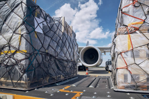 Loading of cargo containers to airplane stock photo