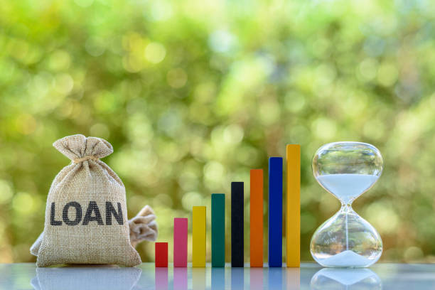 Loan bag, color bar graph, hourglass on a table Personal loan, non-performing assets, financial concept : The image depicting long-term money borrowing between borrower and lender secured by a promissory note student debt stock pictures, royalty-free photos & images