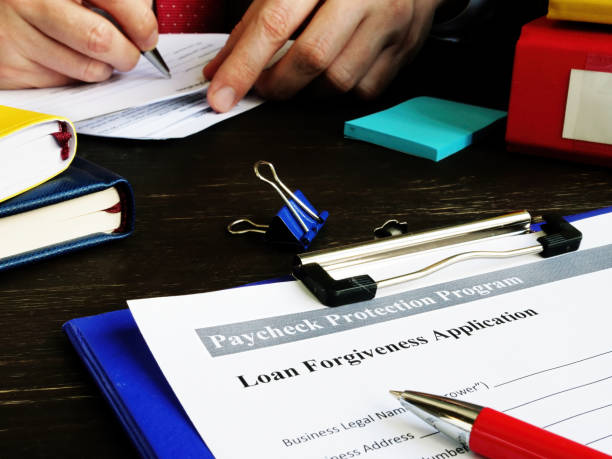 PPP Loan forgiveness application for Paycheck Protection Program in the office. PPP Loan forgiveness application for Paycheck Protection Program in the office. forgiveness stock pictures, royalty-free photos & images