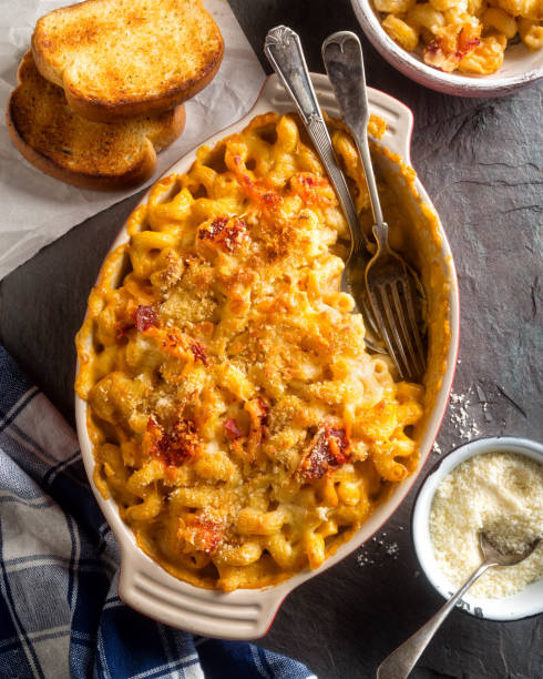 Lobster Mac and Cheese An overhead view of delicious lobster mac and cheese with toasted bread. comfort food stock pictures, royalty-free photos & images