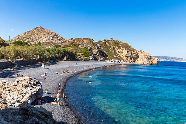 Local and tourist people on Mavra Volia beach in Chios stock photo