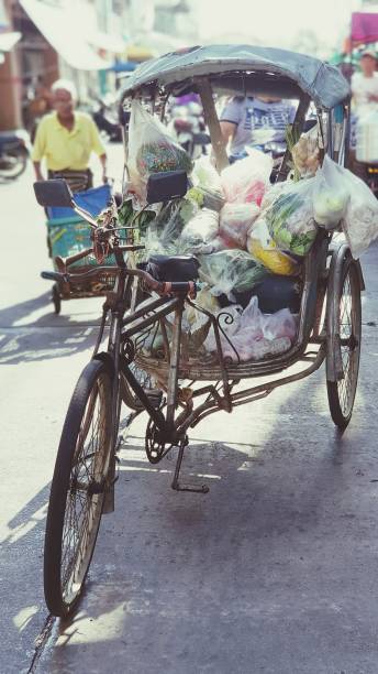 A local storage Tricycle in Thailand A storage vehicle in urban of Thailand adult tricycle stock pictures, royalty-free photos & images