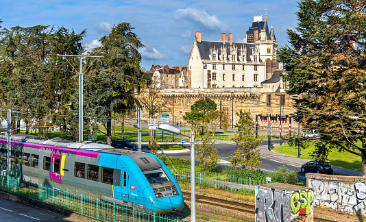 Nantes, France - April 14, 2017: Local train and the Castle of the Dukes of Brittany