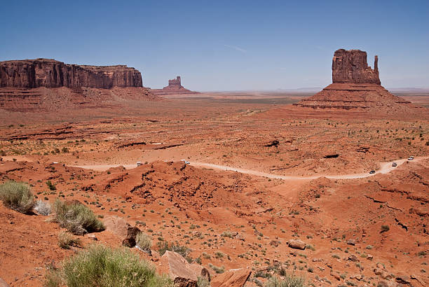 Sentinal Mesa and West Mitten Located on the Arizona/Utah border at an elevation of 5200 feet, Monument Valley is filled with unique sandstone formations. This scene is of the iconic West Mitten and Sentinal Mesa. Monument Valley Tribal is located near Oljato, Utah, USA. jeff goulden monument valley stock pictures, royalty-free photos & images