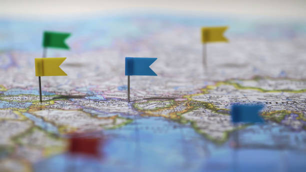 Locations marked with pins on world map, global communication network, closeup stock photo