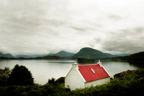 Loch Maree white cottage with red roof stock photo