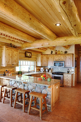 The kitchen and breakfast bar in a modern log cabin in the Idaho mountains.