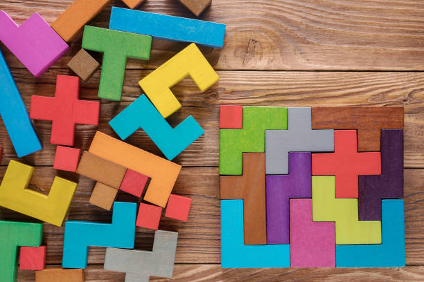 Logical tasks composed of colorful wooden shapes. Visual conundrum. Concept of creative, logical thinking or problem solving. Business concept, rational solution. stock photo