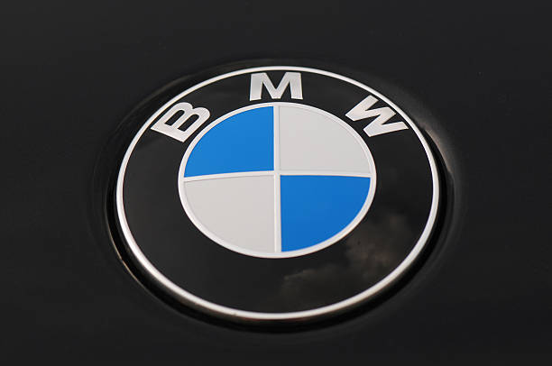 BMW Logo on a Black Car 5 Series "Hanover, Lower Saxony, Germany-September, 4th 2011: BMW 5 Series logo parked at Hanover airport." bmw stock pictures, royalty-free photos & images