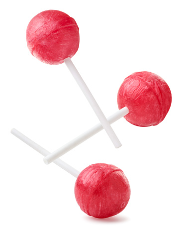 Lollipops falling close-up on a white background. Isolated