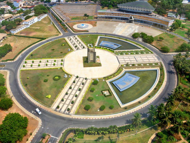 Lomé, Togo - the capital's main square, Independence Square, the center of the city and the country - Palais de Congrés on the top right and Independence monument in the center of the square Lomé, Togo: view over Independence Square (Place de l'Independance), a traffic circle that is the de facto center of the country - seen from above. Hedgerow: Independence, April 27th, 1960. togo stock pictures, royalty-free photos & images