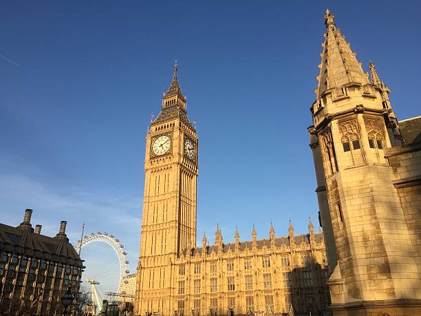 London Houses of Parliament Big Ben blue sky golden sunlight stock photo