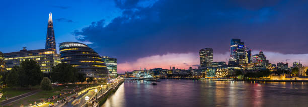 London Shard Embankment illuminated beside River Thames City skyscrapers panorama stock photo