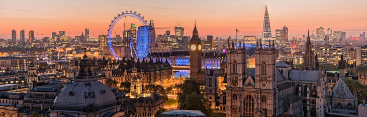London, England, UK - May 3, 2014: London's skyline at Dawn. Taken from the roof tops, some of London's most iconic sights can be seen such as The Shard, Millennium Wheel, Big Ben, Canary Wharf, St Paul's Cathedral, Westminster Abbey and Parliament Square.