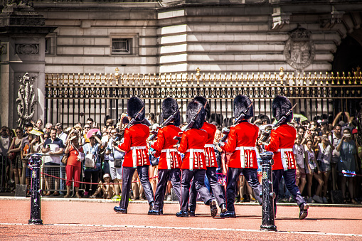 2019_07_24_London UK  Chaning of the Guard at Buckingham Palace as Crowd of tourists blurred in background watch and take pictures - Selective focus