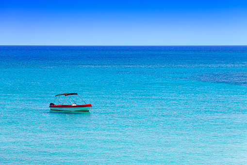 Lone boat in the Mediterranean Sea in the resort village of Protaras on the island of Cyprus.