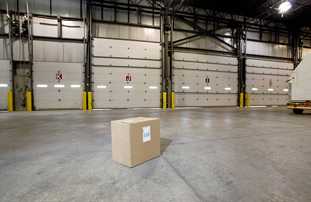 Lone box on warehouse floor stock photo